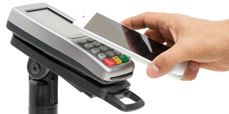Smartphone being held above a payment terminal