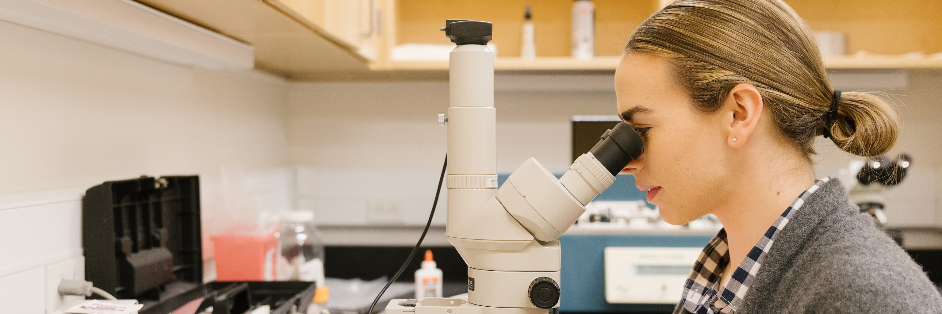 A woman using a microscope