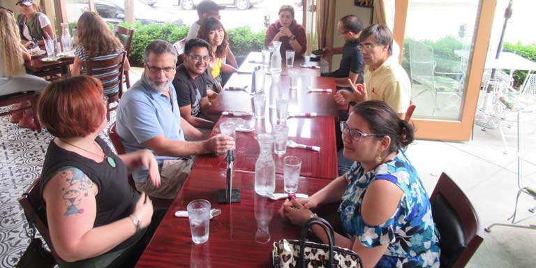Faculty and students gathered around a large table