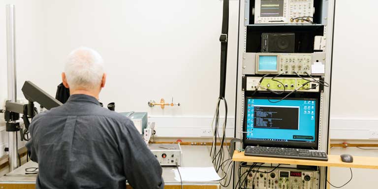 A man working with laboratory machinery.