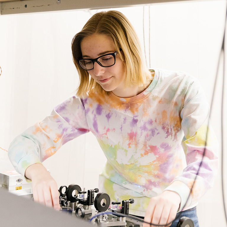 A woman working with lab machinery.